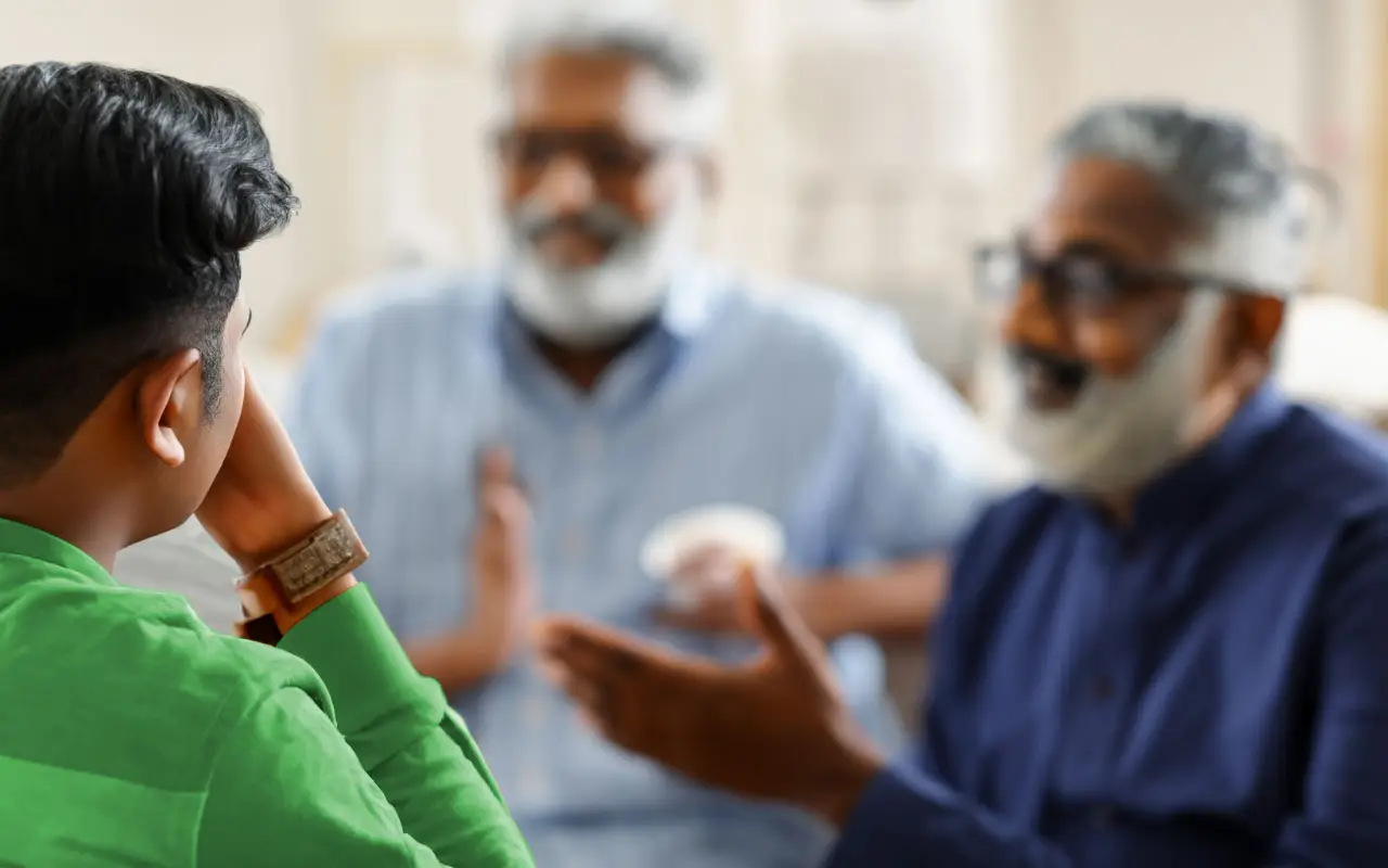 Indian young man listening to his old father for wisdom benefits